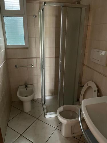 a bathroom with a shower and a toilet and a sink at SALENTO - Casa vacanza - Torre dell’orso in Torre dell'Orso