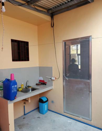 a kitchen with a sink and a shower in a room at Paniqui, Tarlac - Madrid in Anao