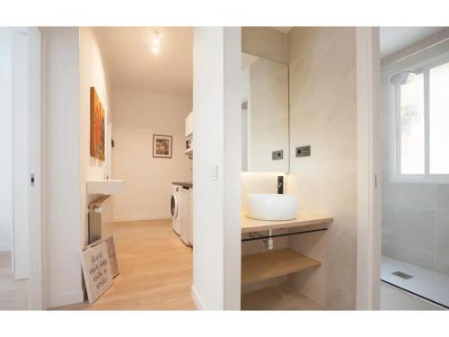 a bathroom with a sink and a mirror at Retiro Park Apartments in Madrid