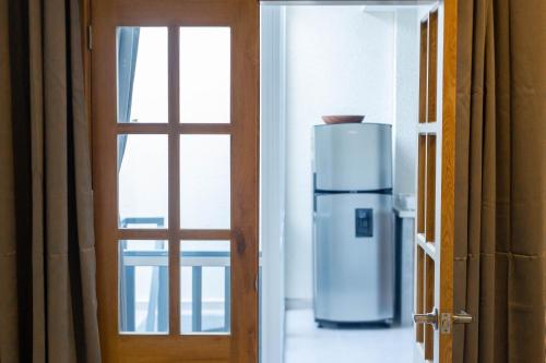 a refrigerator in a room next to a door at Casa Bacoba in Santa Marta