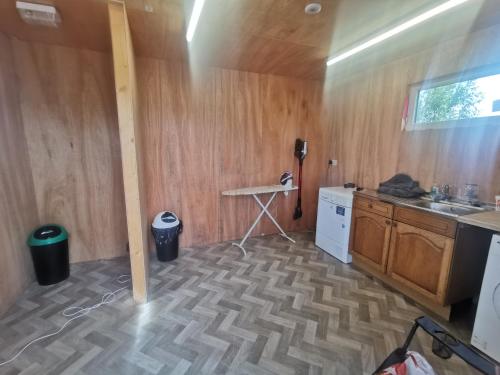 a kitchen with a counter and a table in a room at Glamping Pods Nr Port Isaac in Port Isaac