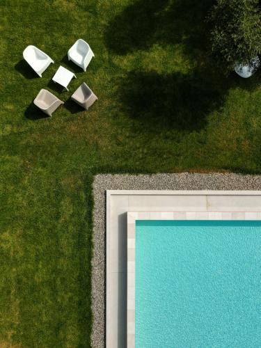 an overhead view of two chairs and a pool at Macchia Piccinna in Maruggio