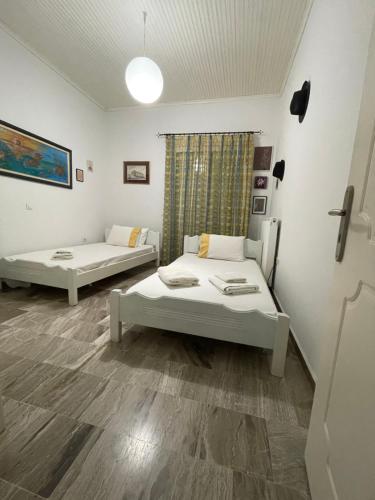 a room with two beds in a room at Mama’s Sunshine Garden Villa in Áyios Ilías