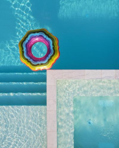 a colorful donut sitting on top of a swimming pool at Macchia Piccinna in Maruggio