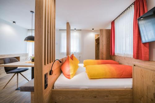 a bedroom with a bed with two pillows on it at Kuenz Dolomites App 2 in San Candido