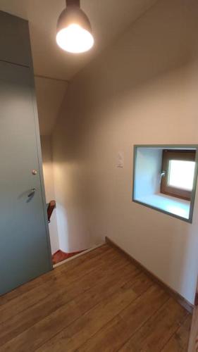 an empty room with a door and a window at Gîte La Mathilde dans les Monts du Forez in Verrières-en-Forez