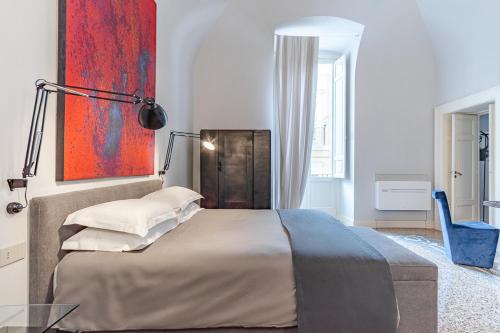 a bedroom with a bed and a painting on the wall at Dimora Bormioli in Bari