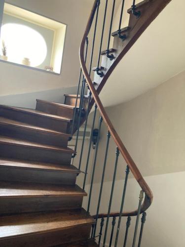 a staircase in a house with wooden stairs at Clos de belle roche in Saint-Romain