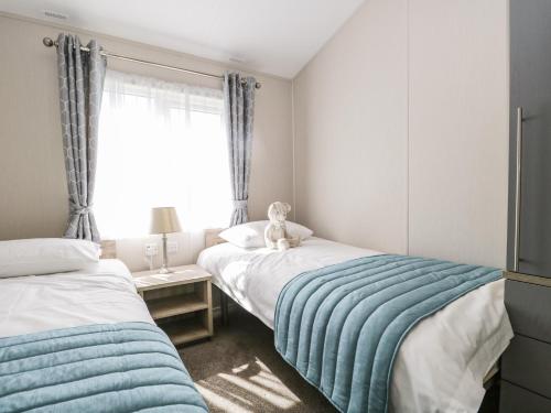 ein Schlafzimmer mit 2 Betten mit einem Teddybär oben drauf in der Unterkunft Parkers Place in Carnforth