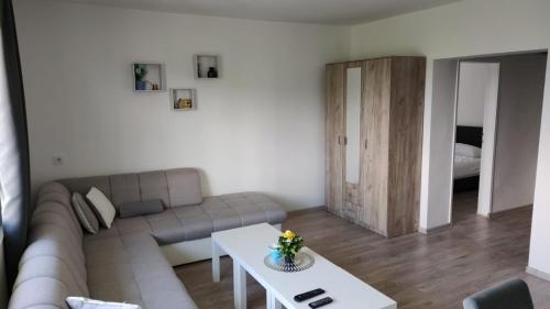 a living room with a couch and a table at Apartman Jorgos in Soko Banja