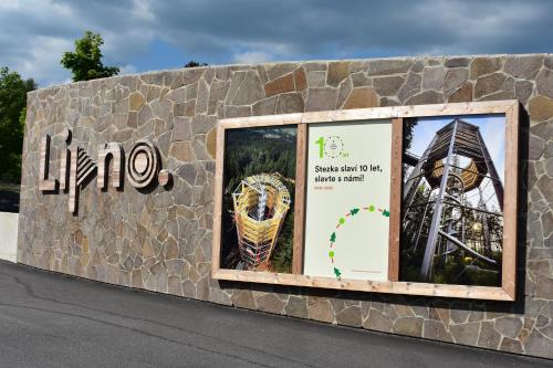 a stone wall with windows on the side of a road at Family home Lipno Lake, Airstay Lipno in Lipno nad Vltavou