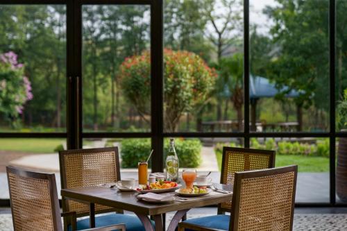 a table with plates of food and drinks on it at Vivanta Katra Vaishno Devi in Katra