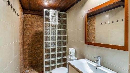 a bathroom with a sink and a toilet and a mirror at Capricho de Luna Atarfe by Ruralidays in Atarfe