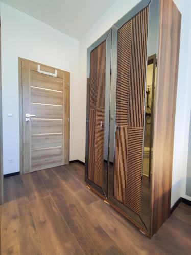a room with two wooden doors and a wooden floor at Intimate Studios Hadersdorf in Hadersdorf am Kamp
