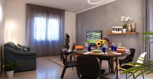 a living room with a dining room table with chairs at Residenza Palmina in Rimini