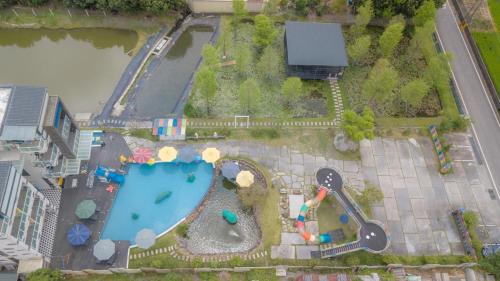 an aerial view of a pool with a playground at Diudiu Dang Paternity B&B in Dongshan