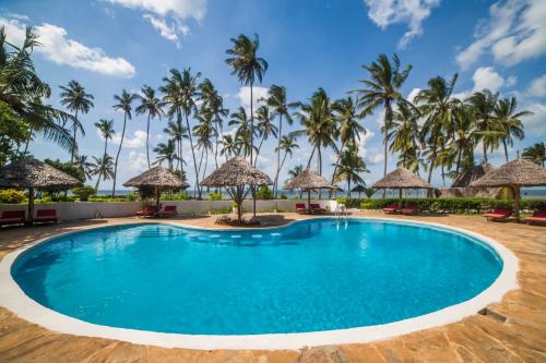 a pool at a resort with palm trees at Antonio Beach Tree House Hotel & Spa in Uroa