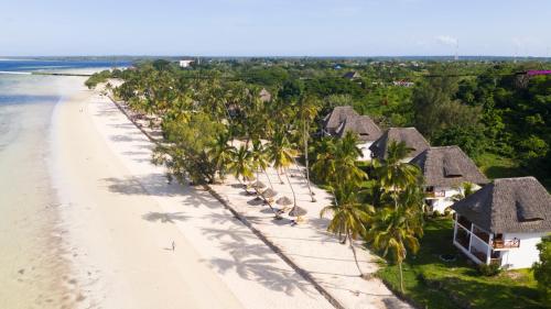 an aerial view of a beach with palm trees and houses at Antonio Beach Tree House Hotel & Spa in Uroa
