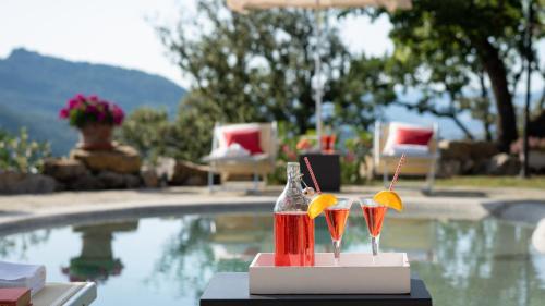 a table with two drink bottles next to a swimming pool at TERRIPI 10, Emma Villas in Pomarance