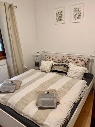 a large bed with two towels on top of it at Small Lake Apartman in Esztergom