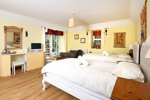 a bedroom with two beds and a living room at Craigadam Lodge with Hot tub in Castle Douglas