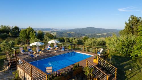 an overhead view of a swimming pool on a wooden deck at Masso delle Fanciulle 14, Emma Villas in Pomarance