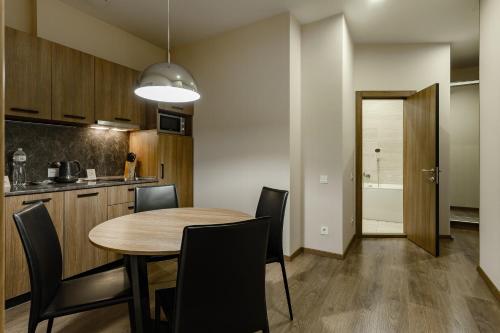 a kitchen and dining room with a table and chairs at Senator Maidan in Kyiv