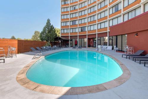 a large swimming pool in front of a building at Clarion Hotel Denver Central in Denver