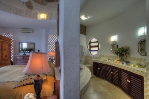 a bedroom with a bed and a bathroom with a sink at Villa Azul in Puerto Vallarta