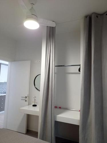 a bathroom with a shower curtain and a sink at Partcon Studio in Private Property A in Neoi Epivates