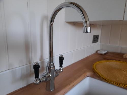 a kitchen sink with a faucet on a counter at Dinky's Den in Coverack