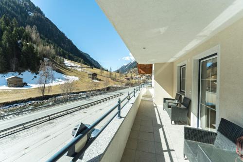 a balcony with a view of a train track at Apart Garni Astrada in Kappl