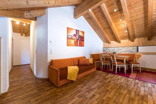 a living room with a couch and a table at Apart Garni Astrada in Kappl