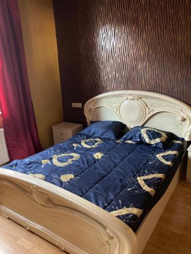 a bed in a bedroom with a blue comforter at Gyumri house in Gyumri