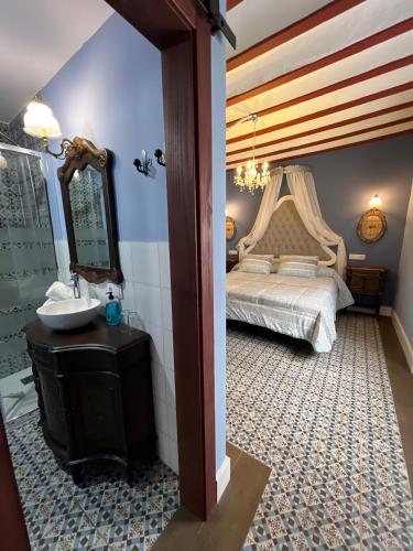 a bedroom with a bed with a sink and a mirror at Retiro del Teatro Almagro in Almagro
