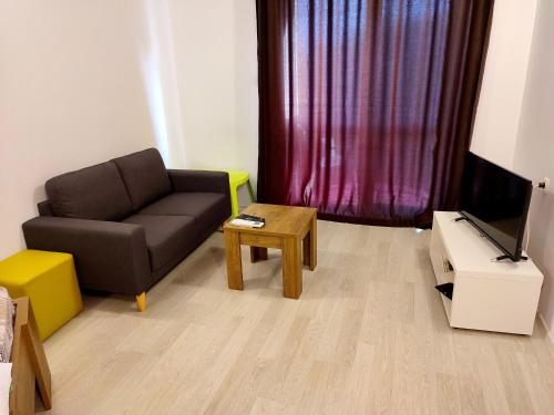 a living room with a couch and a coffee table at Apartments Alexandra in Opanets