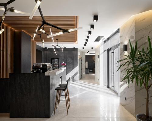 a lobby with a counter and a bar with a stool at Ribas Rooms Bila Tserkva in Bila Tserkva
