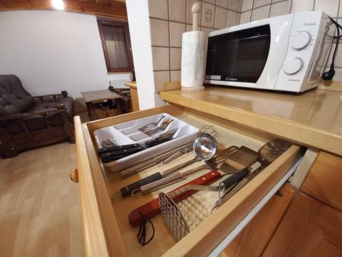 a drawer in a kitchen with a microwave at Vineyard Cottage Maleric with Pool Access in Dragatuš