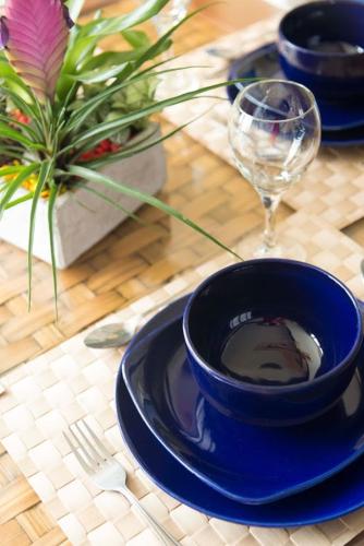 a table with two blue plates and a wine glass at Divi Aruba Phoenix Beach Resort in Palm-Eagle Beach