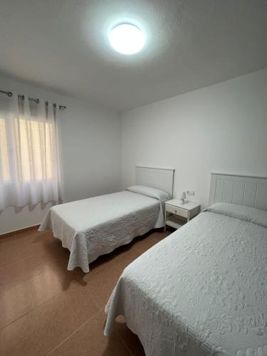 Кровать или кровати в номере Apartamento Cristina 1D