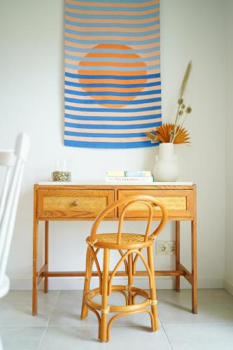 a wooden desk with a chair in front of it at Birds of Paradise - Boutique Surf Lodge in Aljezur