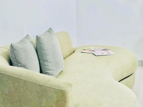 a chair with two pillows and a magazine on it at Canaryislandshost l Boya Suites in Playa Honda