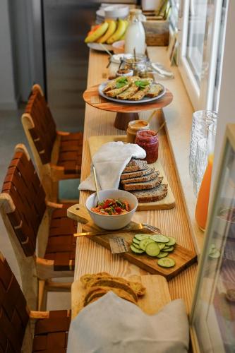 a long table with plates of food on it at Birds of Paradise - Boutique Surf Lodge in Aljezur