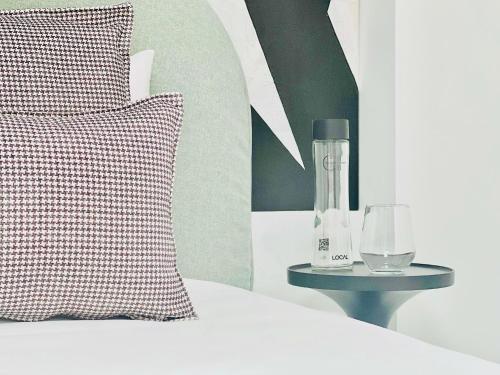 a bed with a pillow and a blender on a table at Canaryislandshost l Boya Suites in Playa Honda