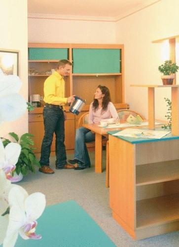a man and a woman standing in a room at Hotel Marko in Nötsch