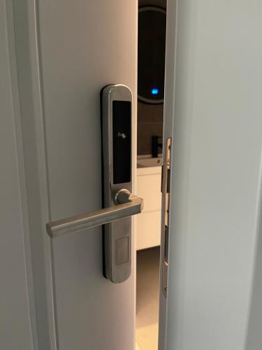 a refrigerator with a phone sticking out of it at Ladi Rooms in Tirana