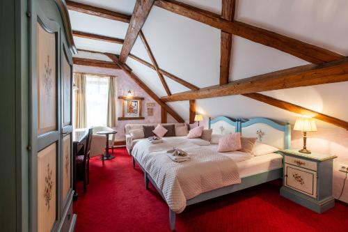 a bedroom with a large bed in a attic at Pension Lectar in Radovljica