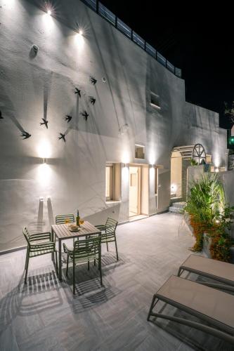 a patio with a table and chairs in front of a building at Wine and Yard Caves in Pirgos