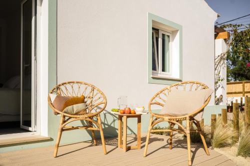 two chairs and a table on a patio at Birds of Paradise - Boutique Surf Lodge in Aljezur