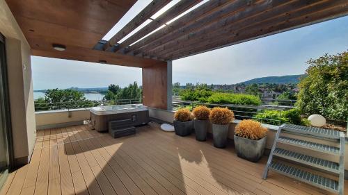 an outdoor deck with a view of the water at Silver DeLux Apartman in Balatonfüred